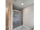 Tiled shower with glass doors and modern fixtures at 68 Jeffrey Ln, Dallas, GA 30157