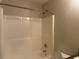 A clean bathroom features a shower-tub combo and classic design at 1241 Key Manor Ln, Lawrenceville, GA 30045
