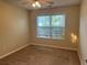 Cozy bedroom featuring natural light, neutral walls, and a ceiling fan at 1241 Key Manor Ln, Lawrenceville, GA 30045