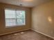 Comfortable bedroom showcasing a bright window and plush carpeting at 1241 Key Manor Ln, Lawrenceville, GA 30045