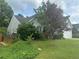 A quaint home with grey siding, a two-car garage, and a cozy, tree-lined yard at 1241 Key Manor Ln, Lawrenceville, GA 30045