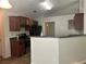 Well-equipped kitchen with dark wood cabinets, black appliances, and granite countertop bar at 1241 Key Manor Ln, Lawrenceville, GA 30045
