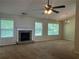 Cozy living room showcasing a stone fireplace and large windows for natural light at 1241 Key Manor Ln, Lawrenceville, GA 30045