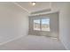 Bedroom with neutral walls, plush carpet, and natural light through large windows at 141 Frontier Way, Mcdonough, GA 30253