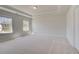 Bright bedroom featuring tray ceilings, plush carpet and multiple windows at 141 Frontier Way, Mcdonough, GA 30253