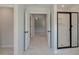 Hallway featuring a shower, white doors, and marble floors at 141 Frontier Way, Mcdonough, GA 30253