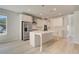 Bright kitchen features white cabinets, stainless steel appliances, a large island, and modern pendant lighting at 141 Frontier Way, Mcdonough, GA 30253