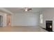Living room has neutral paint, modern fireplace, and a ceiling fan at 141 Frontier Way, Mcdonough, GA 30253
