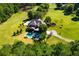 Lush estate featuring a pool, patio, manicured lawn, and mature trees at 197 Westbrook Rd, Carrollton, GA 30116