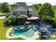 Expansive backyard featuring a freeform pool, lounge area and covered patio at 197 Westbrook Rd, Carrollton, GA 30116