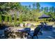 Beautiful backyard featuring fire pit with Adirondack chairs, and mature trees at 197 Westbrook Rd, Carrollton, GA 30116