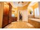 Bathroom boasting double doors, granite countertops, tub and custom cabinetry at 197 Westbrook Rd, Carrollton, GA 30116