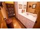 Well-lit bathroom featuring white vanity, framed mirror, and coordinated shower curtain at 197 Westbrook Rd, Carrollton, GA 30116