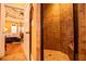 Bathroom showcasing a tiled shower and a doorway to the spacious main bedroom at 197 Westbrook Rd, Carrollton, GA 30116