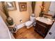 Elegant powder room featuring dark wood vanity, granite countertop, and decorative mirror at 197 Westbrook Rd, Carrollton, GA 30116