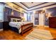 Stylish bedroom with a tray ceiling, hardwood floors, and sports memorabilia at 197 Westbrook Rd, Carrollton, GA 30116