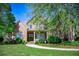 Charming two-story brick home boasts a covered porch and beautifully landscaped front yard at 197 Westbrook Rd, Carrollton, GA 30116