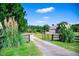 View of a home situated on a expansive lot, accessed via a private drive and gated entrance at 197 Westbrook Rd, Carrollton, GA 30116