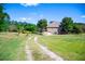 A brick home with a long driveway situated on a large lot with mature trees at 197 Westbrook Rd, Carrollton, GA 30116
