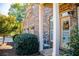 Charming brick home with a three-car garage, featuring a covered front porch with white columns and manicured landscaping at 197 Westbrook Rd, Carrollton, GA 30116