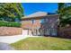 A brick home showing the rear entry garage, with mature landscaping and manicured lawn at 197 Westbrook Rd, Carrollton, GA 30116