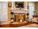 Living room with cozy stone fireplace and white mantle, with lots of natural light at 197 Westbrook Rd, Carrollton, GA 30116