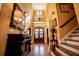 Elegant foyer showcasing hardwood floors, a statement chandelier, and a staircase, creating a sophisticated entrance at 197 Westbrook Rd, Carrollton, GA 30116