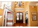 Bright foyer with hardwood floors, featuring a large chandelier and double doors, offering a warm welcome at 197 Westbrook Rd, Carrollton, GA 30116
