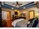 Spacious main bedroom featuring a tray ceiling, an adjacent desk area and ensuite bathroom at 197 Westbrook Rd, Carrollton, GA 30116