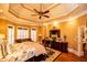 Luxurious main bedroom with tray ceiling, natural light, and hardwood floors at 197 Westbrook Rd, Carrollton, GA 30116