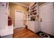 Mudroom with white cabinets and storage, built-in bench, and access to the outdoors at 197 Westbrook Rd, Carrollton, GA 30116