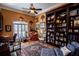 Cozy office with a large bookshelf, a comfortable seating area, and natural light, ideal for reading and relaxation at 197 Westbrook Rd, Carrollton, GA 30116