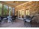 Relaxing screened porch with brick accents, ceiling fan, and comfortable seating arrangement at 197 Westbrook Rd, Carrollton, GA 30116