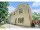 Back of the home featuring neutral siding, brick accents, large windows, walk-out access to a concrete patio at 5003 Village Terrace Dr, Dunwoody, GA 30338