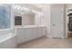 Bathroom featuring double vanity, soaking tub, and large mirror at 5003 Village Terrace Dr, Dunwoody, GA 30338