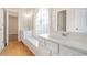 Bathroom featuring double sinks, a stained-glass window, and hardwood floors at 5003 Village Terrace Dr, Dunwoody, GA 30338