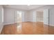 Bright bedroom featuring hardwood floors and open doorways leading to the ensuite and hallway at 5003 Village Terrace Dr, Dunwoody, GA 30338