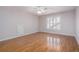 Bedroom with hardwood floors, a ceiling fan, and a window with shutter blinds at 5003 Village Terrace Dr, Dunwoody, GA 30338