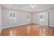 Bright bedroom with hardwood floors and ensuite bathroom access through double doors at 5003 Village Terrace Dr, Dunwoody, GA 30338