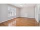 Bedroom with hardwood floors, a ceiling fan, a window with shutter blinds, and white walls at 5003 Village Terrace Dr, Dunwoody, GA 30338
