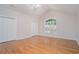 Spacious bedroom with vaulted ceiling, large window, hardwood flooring, and plenty of closet space at 5003 Village Terrace Dr, Dunwoody, GA 30338