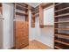 Walk in closet with wood shelving and storage drawers at 5003 Village Terrace Dr, Dunwoody, GA 30338