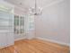 Elegant dining area with hardwood floors, built-in cabinets, and modern lighting at 5003 Village Terrace Dr, Dunwoody, GA 30338