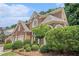 Well-maintained brick home with an attached two-car garage and a nicely landscaped front yard at 5003 Village Terrace Dr, Dunwoody, GA 30338