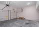 Spacious two-car garage featuring two white overhead doors, concrete floors, and overhead storage at 5003 Village Terrace Dr, Dunwoody, GA 30338