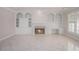 Elegant living room featuring a fireplace, built-in shelving, and plantation shutters at 5003 Village Terrace Dr, Dunwoody, GA 30338