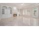Spacious living room with a fireplace, built-in shelves, and a large window at 5003 Village Terrace Dr, Dunwoody, GA 30338