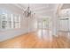 Bright living room with hardwood floors, shuttered windows, and arched doorways at 5003 Village Terrace Dr, Dunwoody, GA 30338
