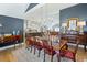 Elegant dining room with wood table set, decorative lighting, and access to the kitchen and living areas at 8175 Main St, Woodstock, GA 30188