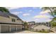 Stunning white home with a three-car garage and a beautiful outdoor entertaining area and swimming pool at 8175 Main St, Woodstock, GA 30188